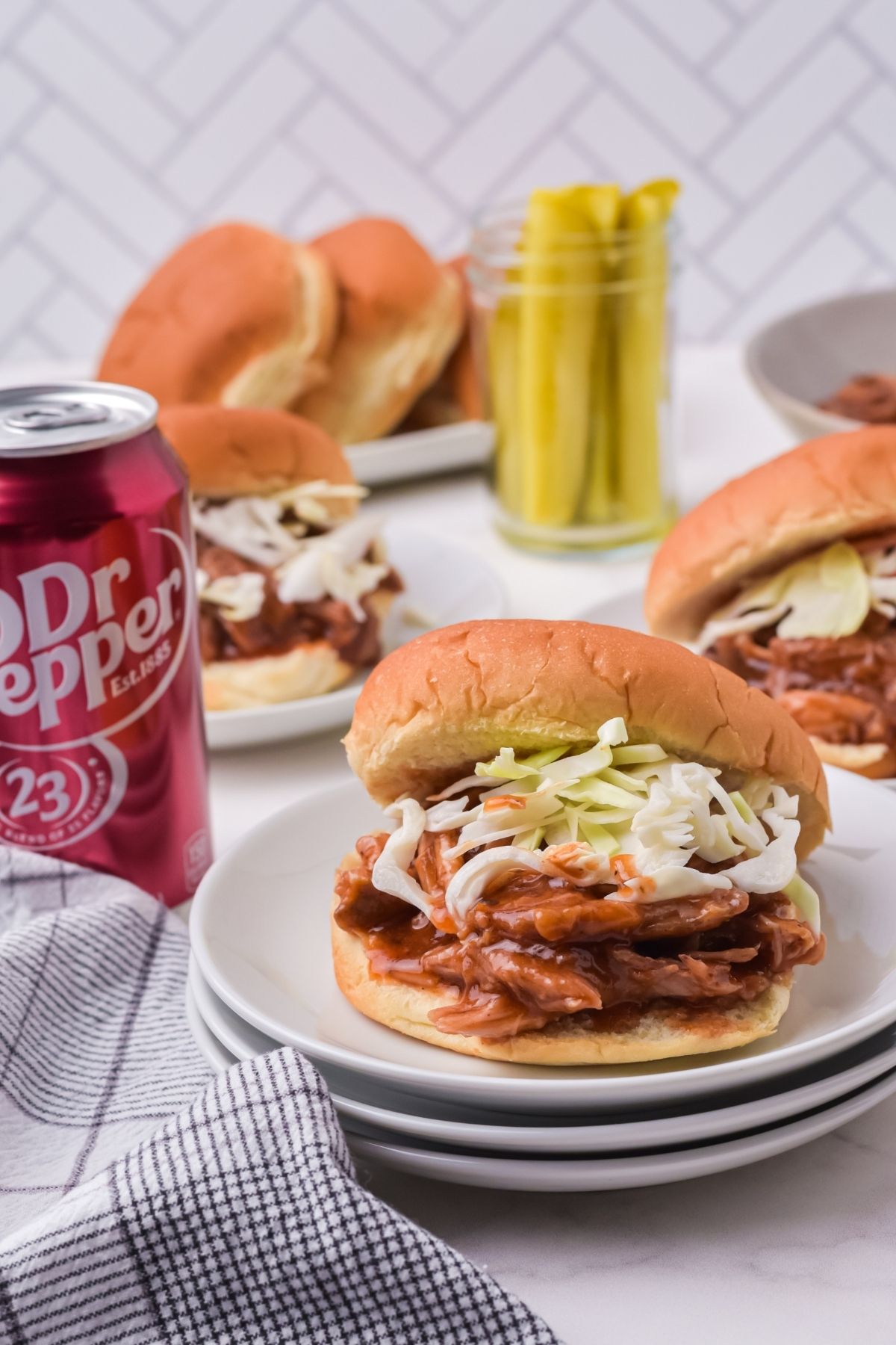pulled pork on buns with cole slaw and Dr. Pepper on the side