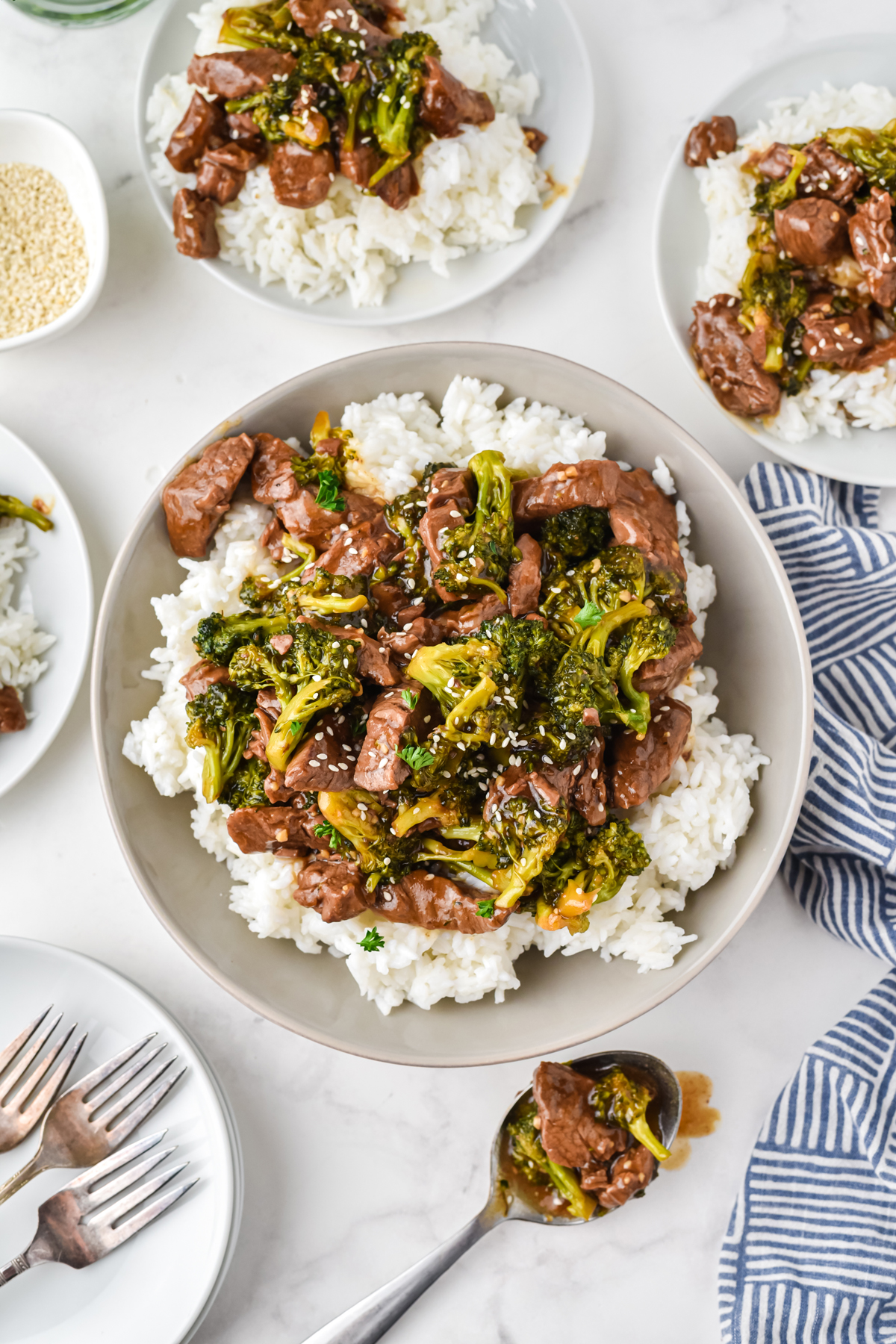 Beef and Broccoli on white plates with rice. 