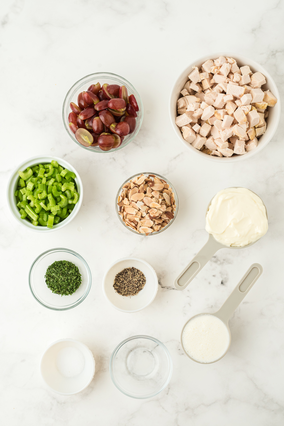 Ingredients of Neiman Marcus Chicken Salad on a white counter