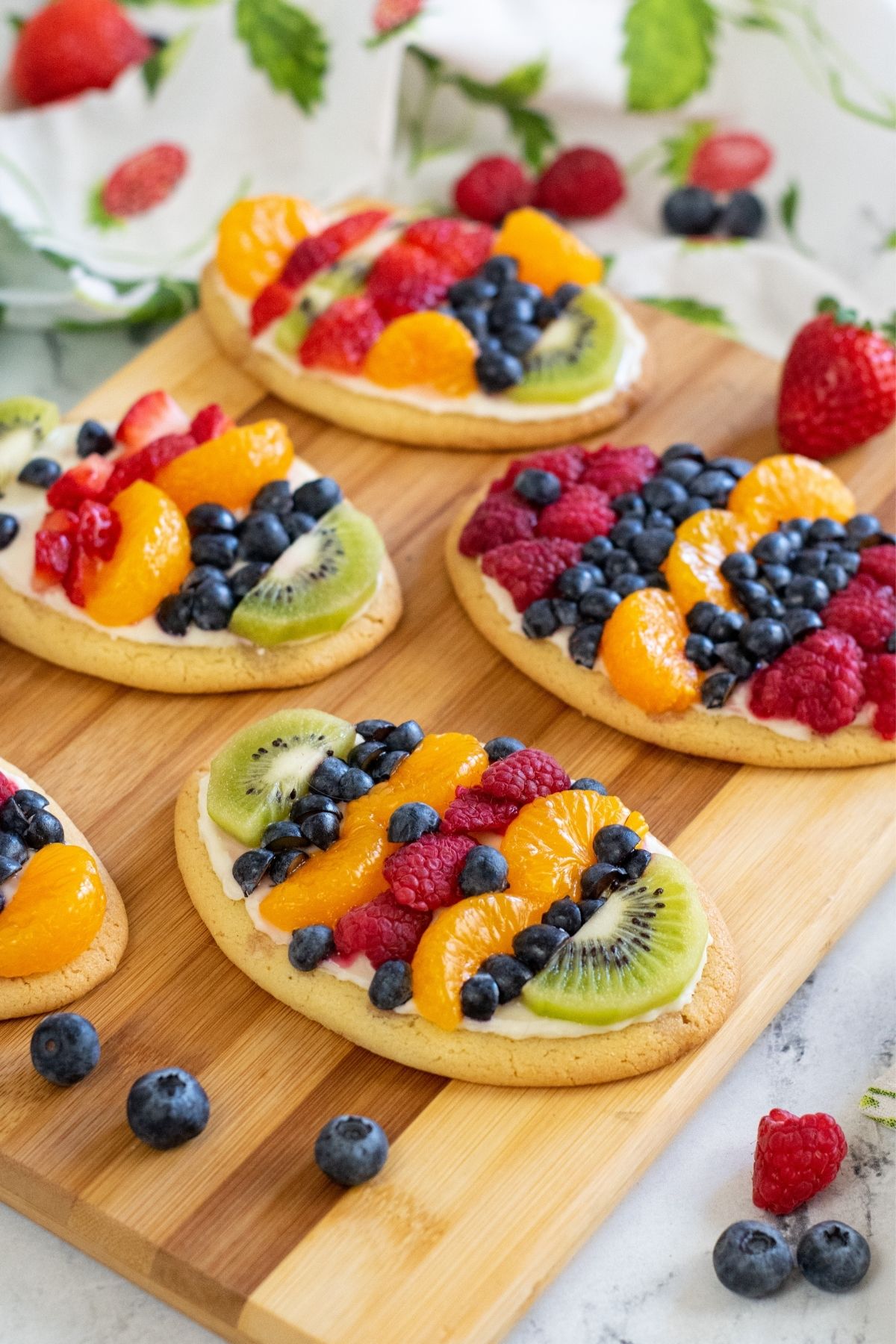mini fruit pizzas in the shape of Easter eggs on cutting board