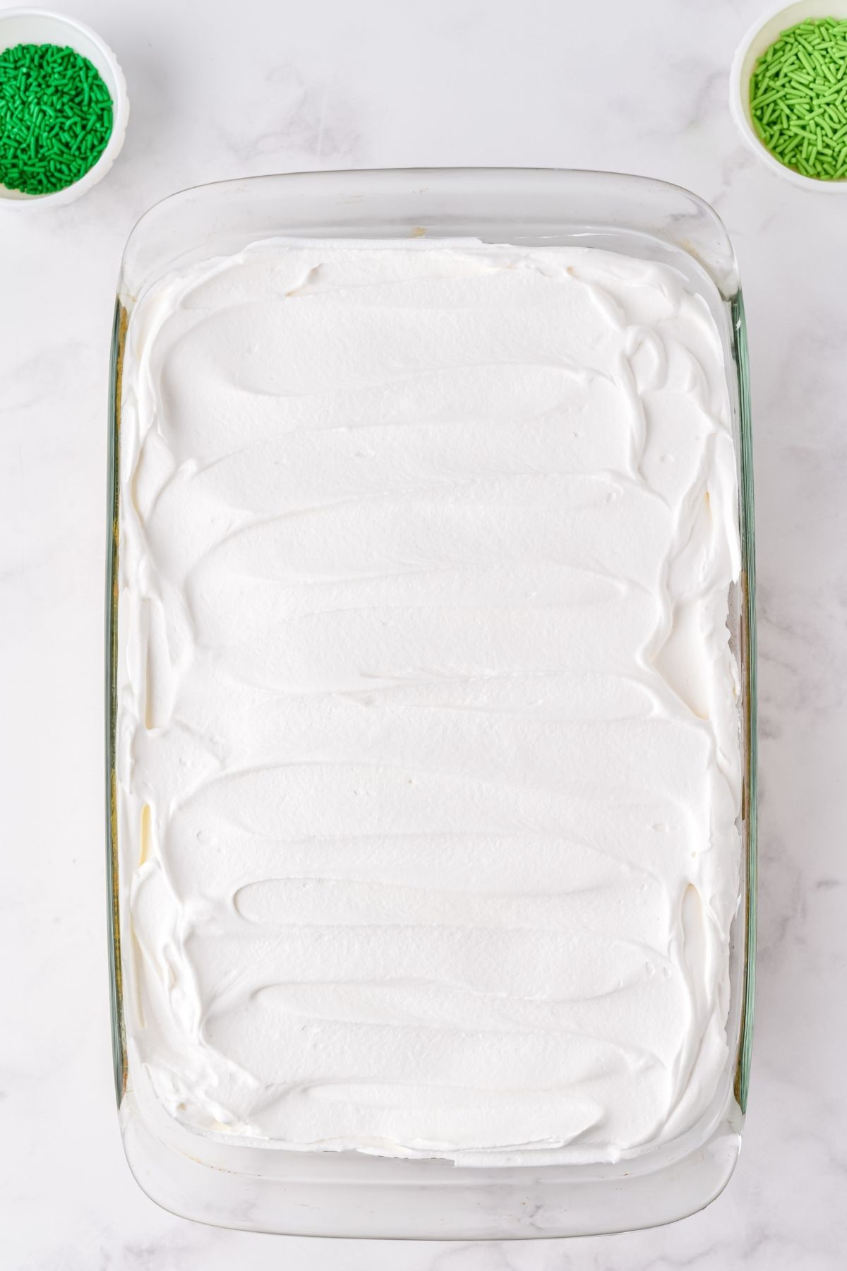 whipped topping spread on top of cake