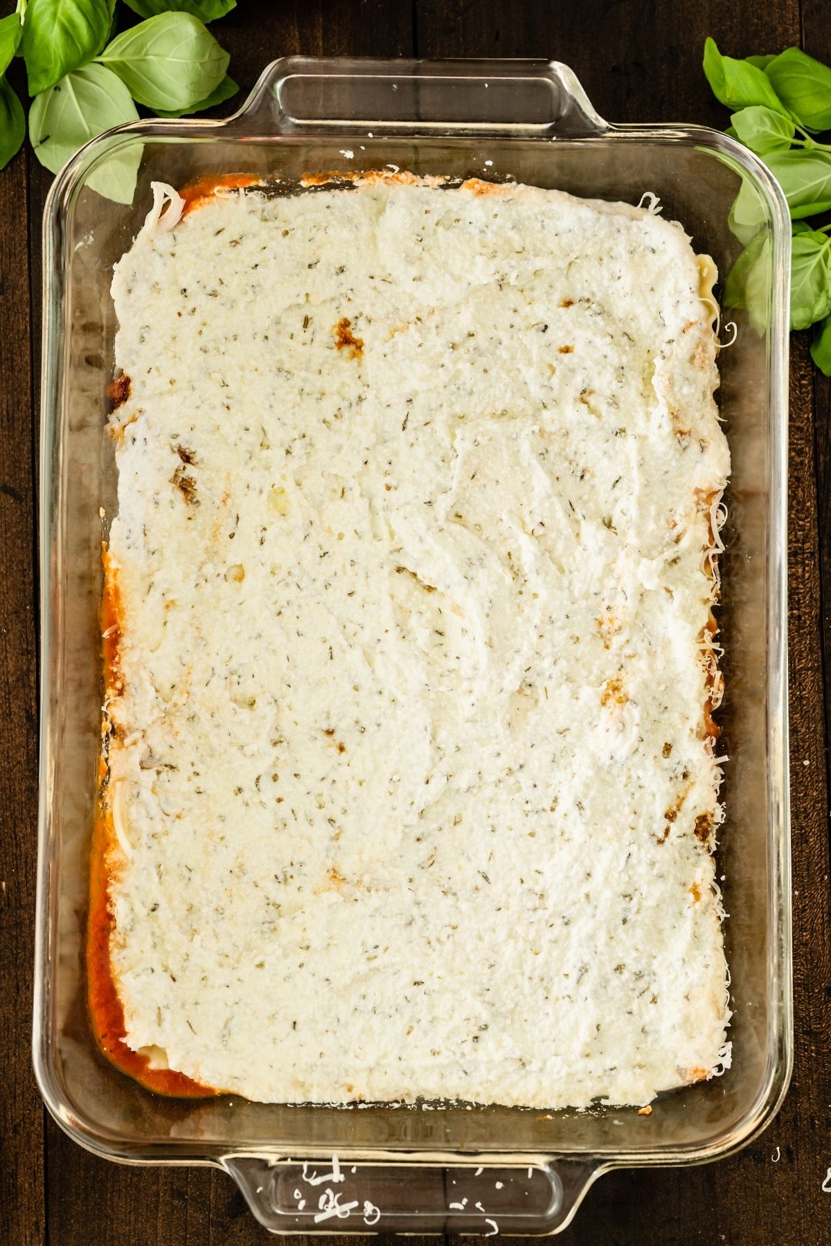 glass baking dish with layers of lasagna, cheese mixture layer