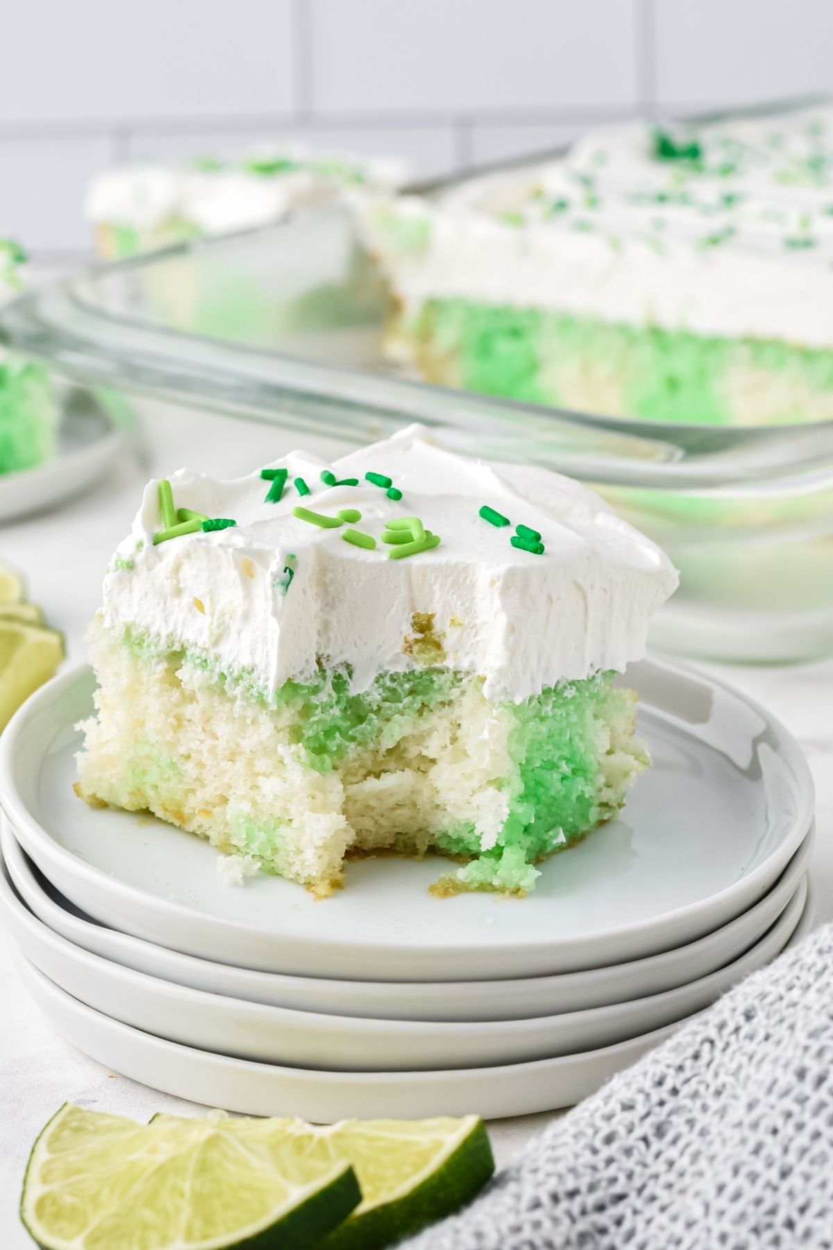 green and white cake with whipped cream topping and green sprinkles