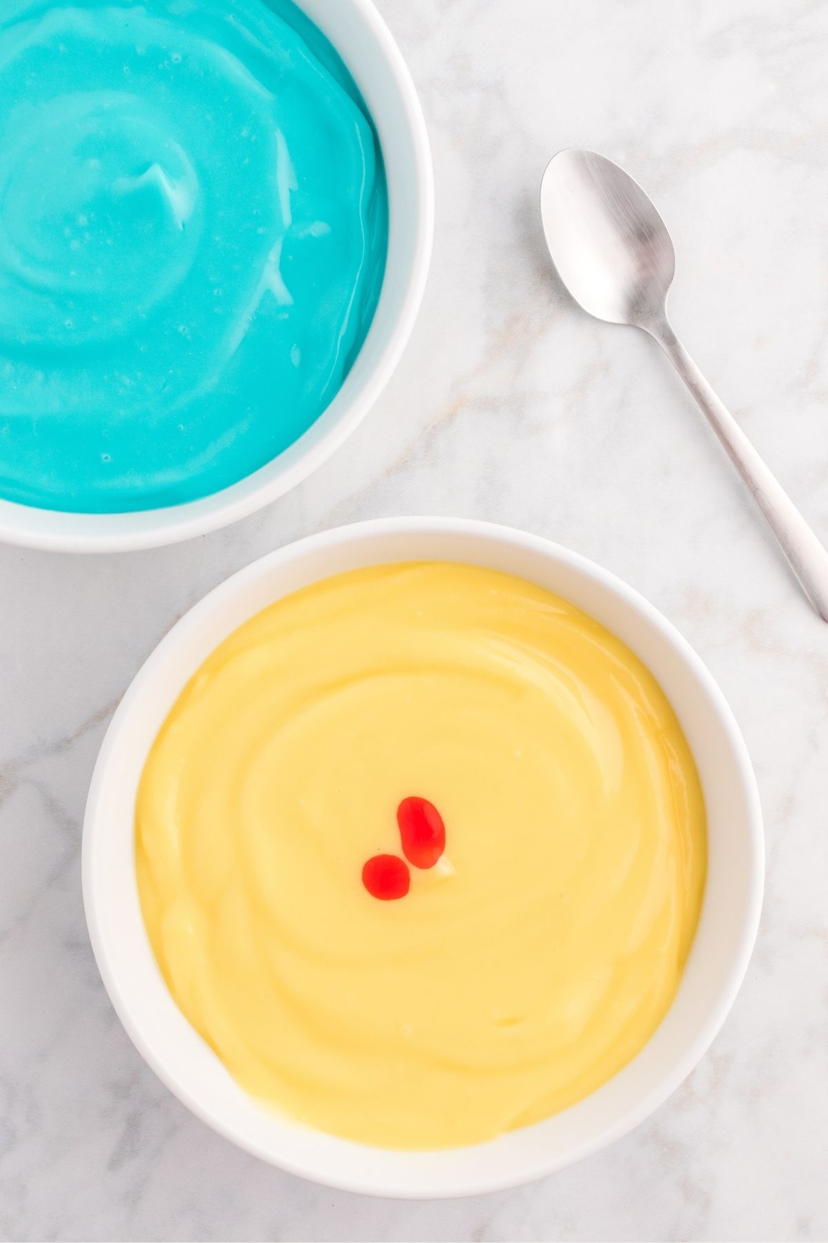 teal pudding, and yellow pudding with drop of food coloring in it