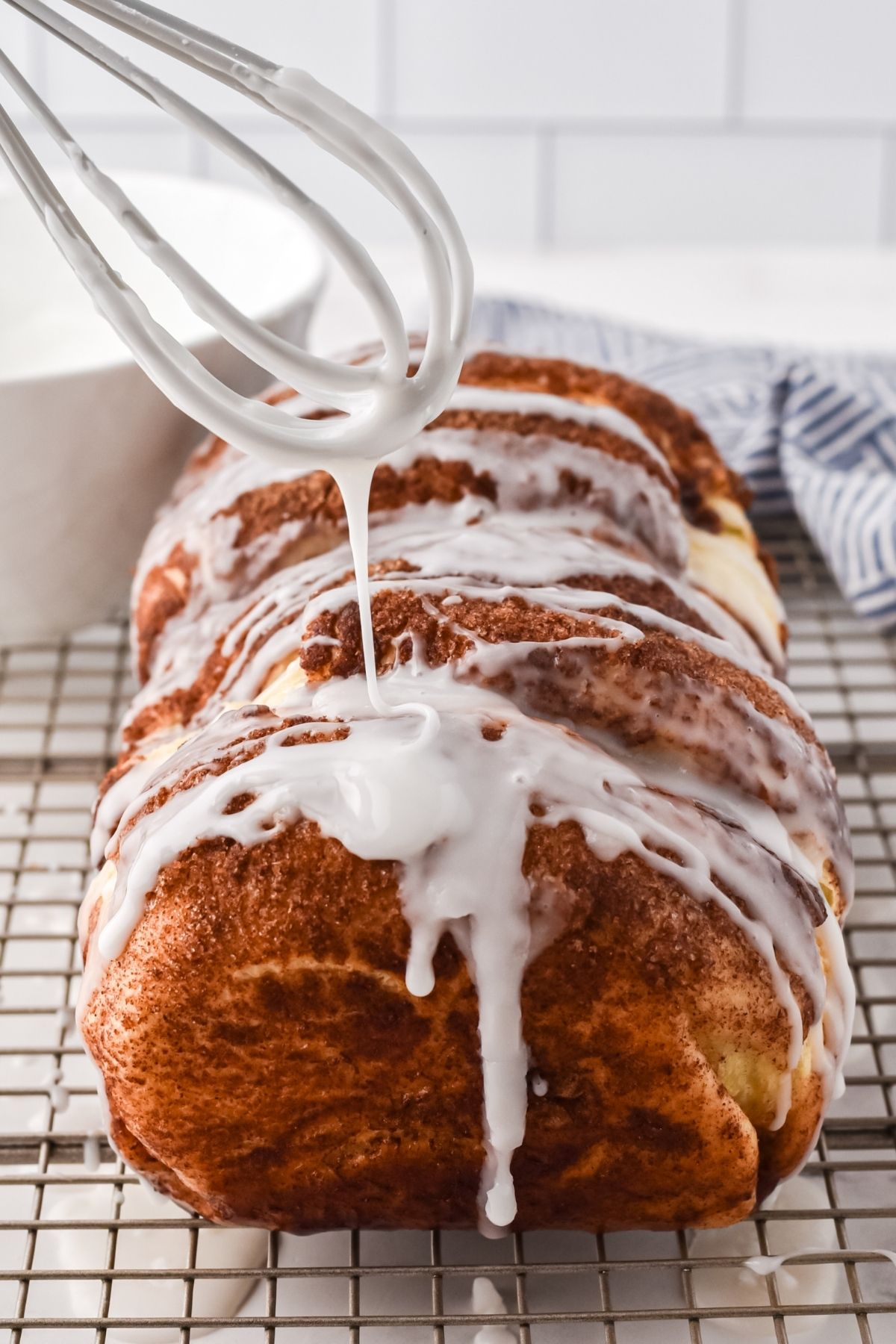 whisk dripping frosting on bread loaf