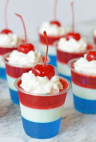 red white and blue jello shots with whipped cream and cherries