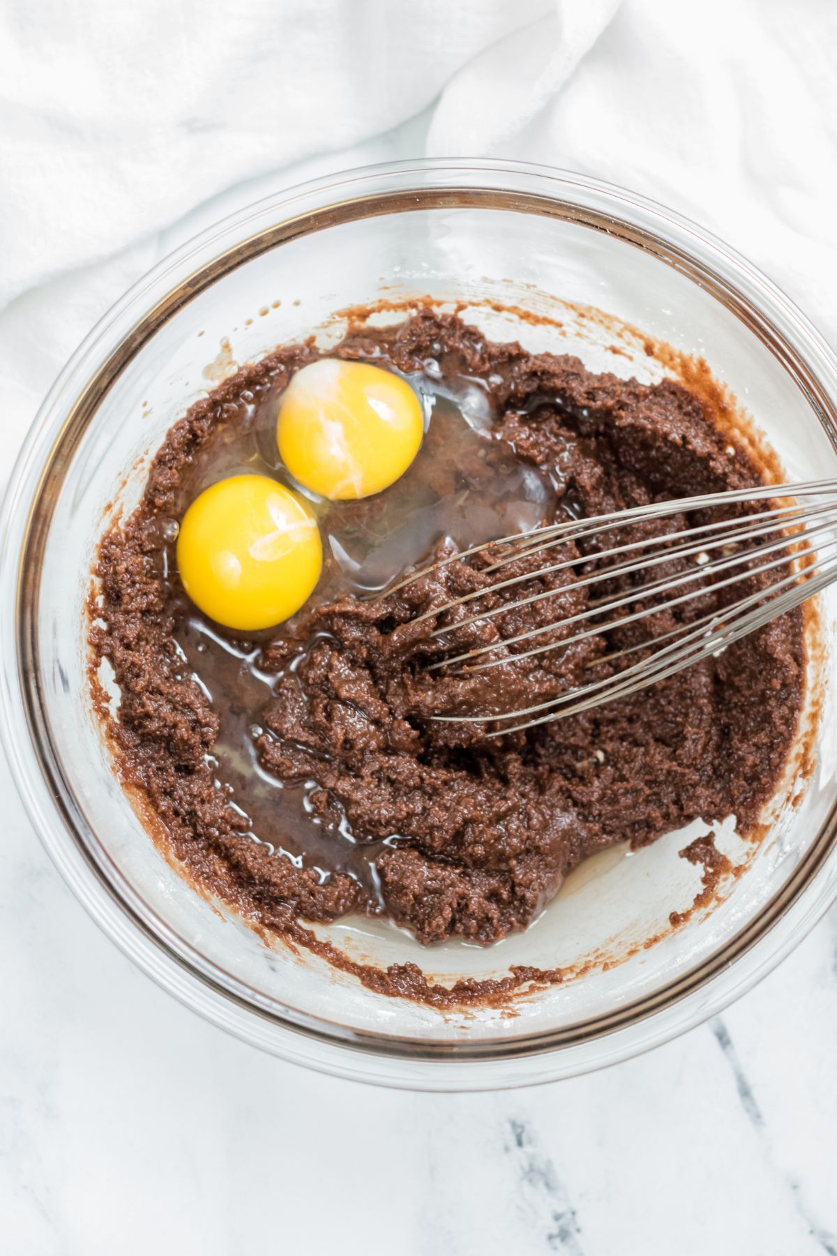 brownie mixture with eggs and whisk