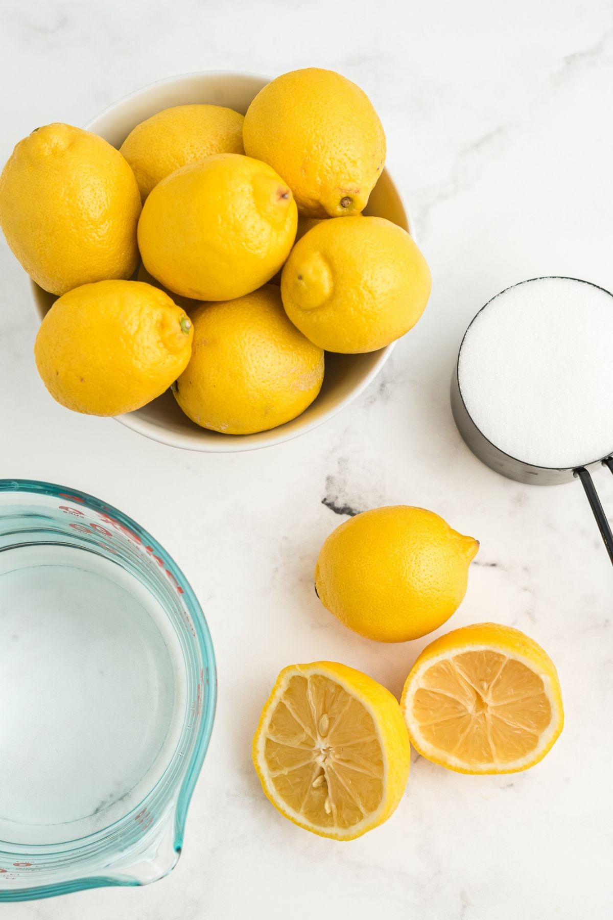 lemons in bowl, sugar, and water