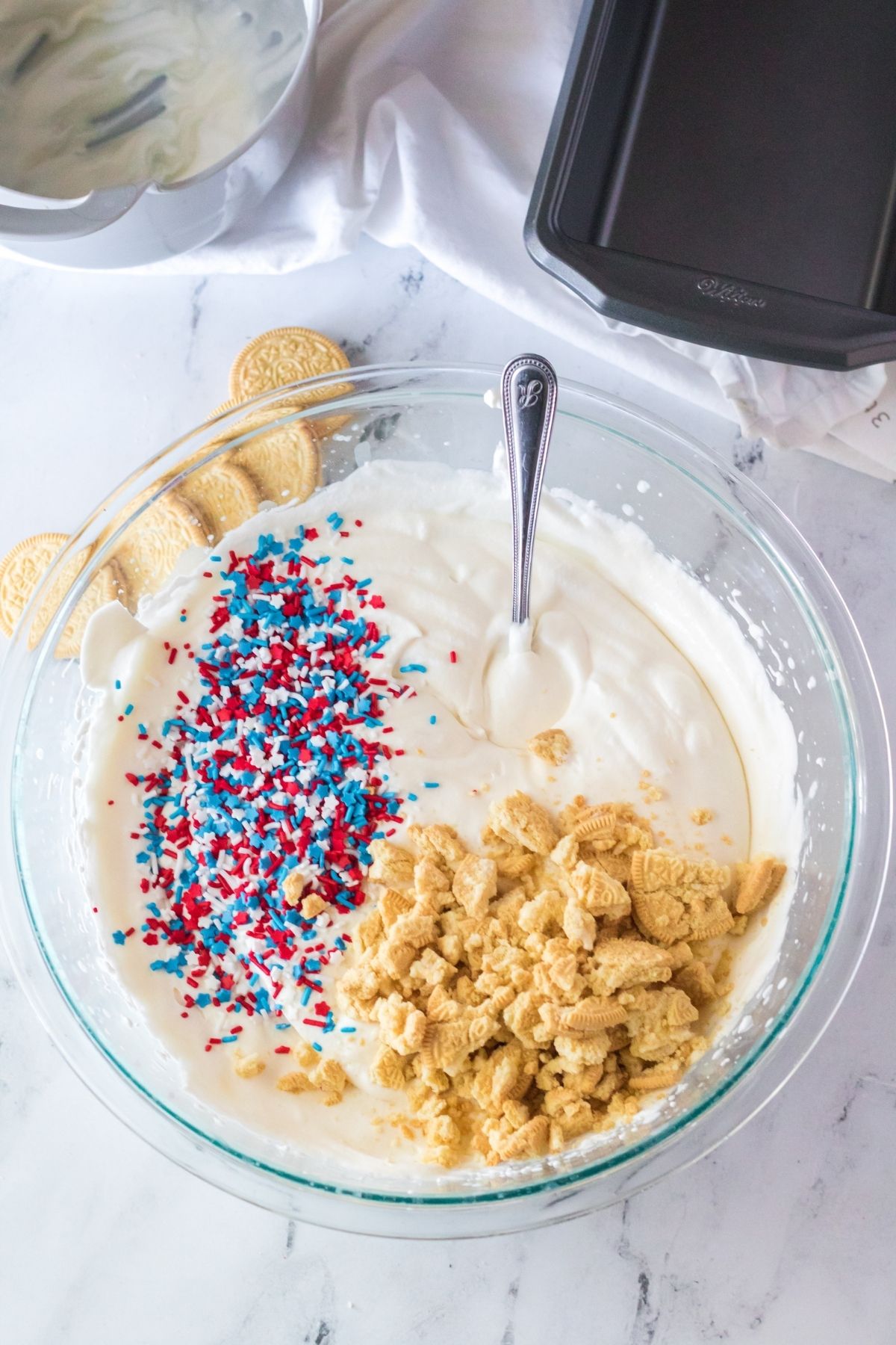 sprinkled and crushed Golden Oreos in ice cream mixture