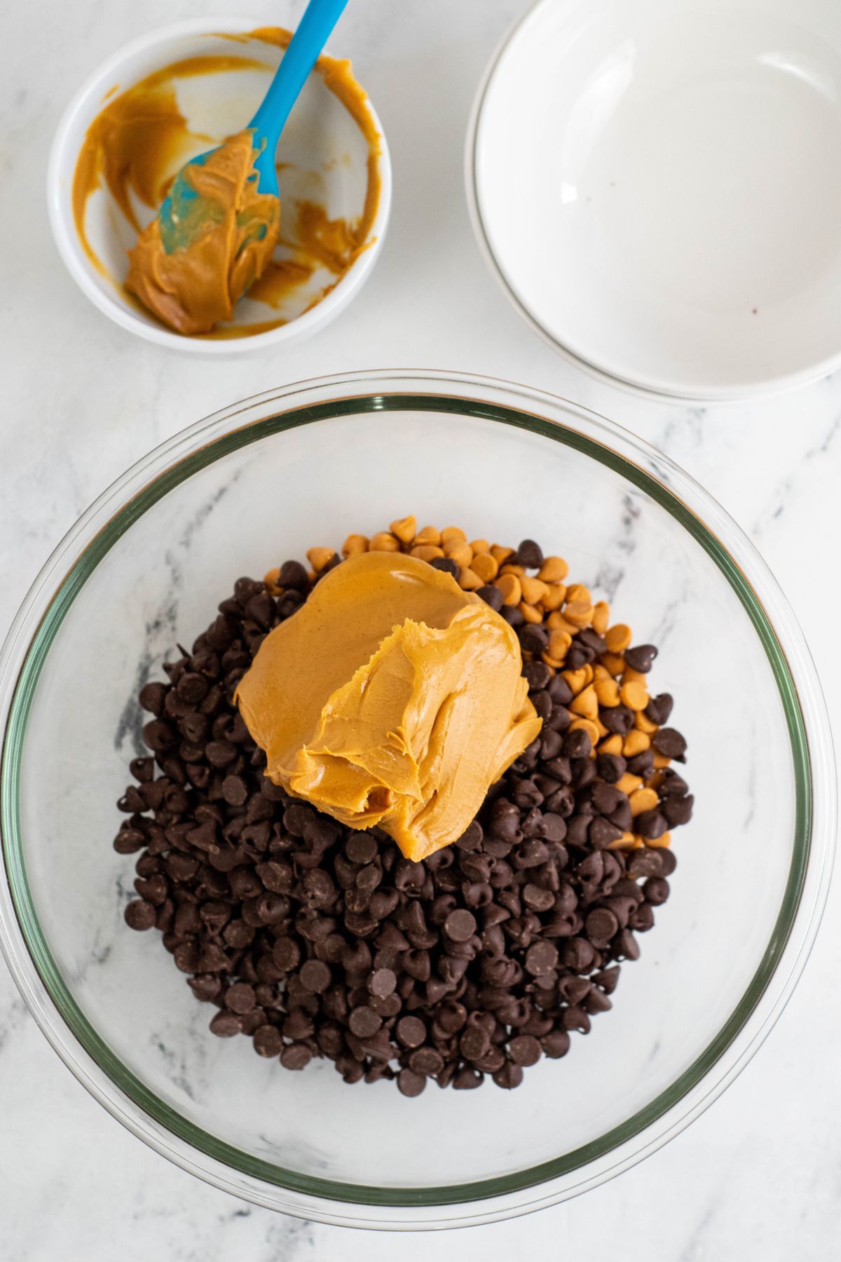 chocolate and butterscotch chips with peanut butter in clear bowl