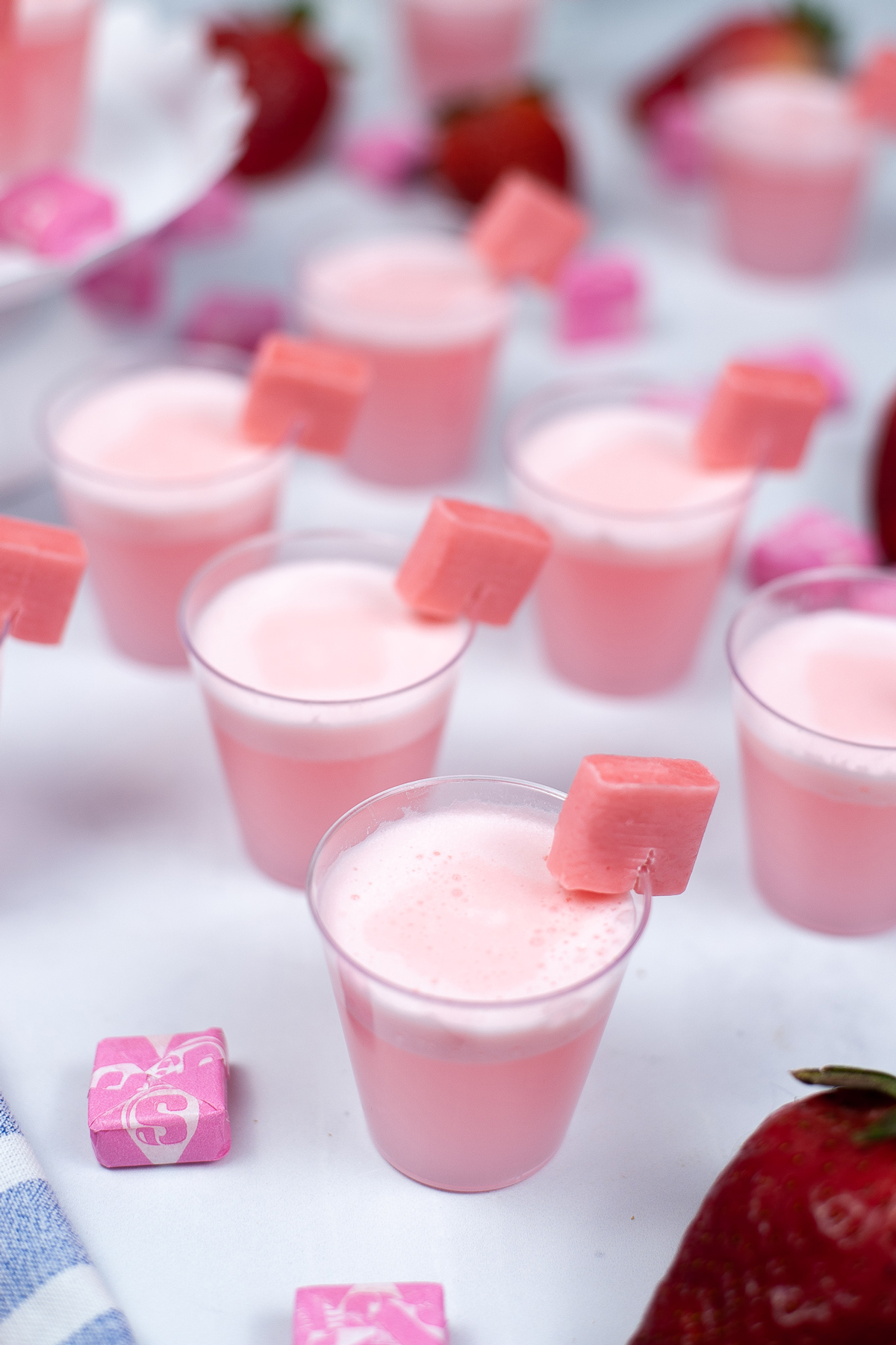 pink shots in cups with starburst candy on side