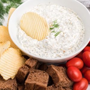 white dill dip in bowl with fresh dill on top