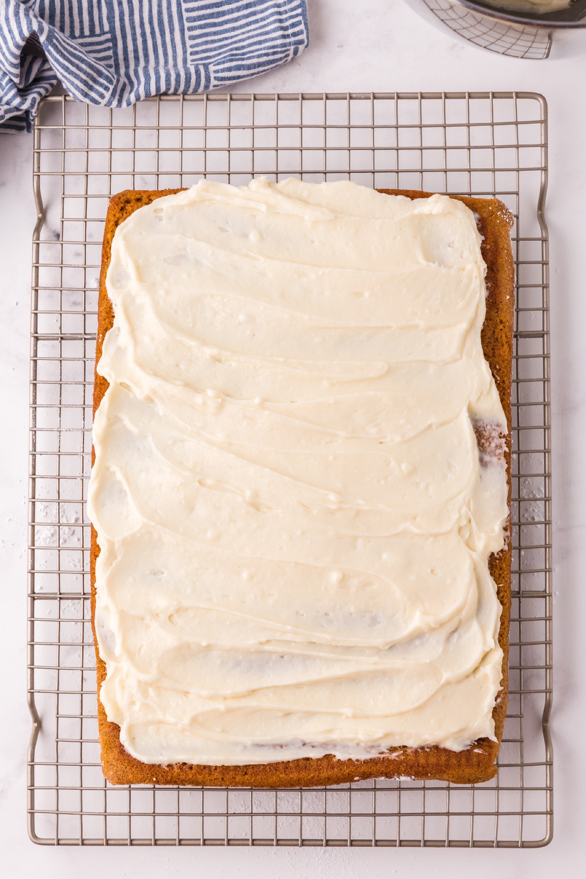 white filling spread on top of pumpkin cake