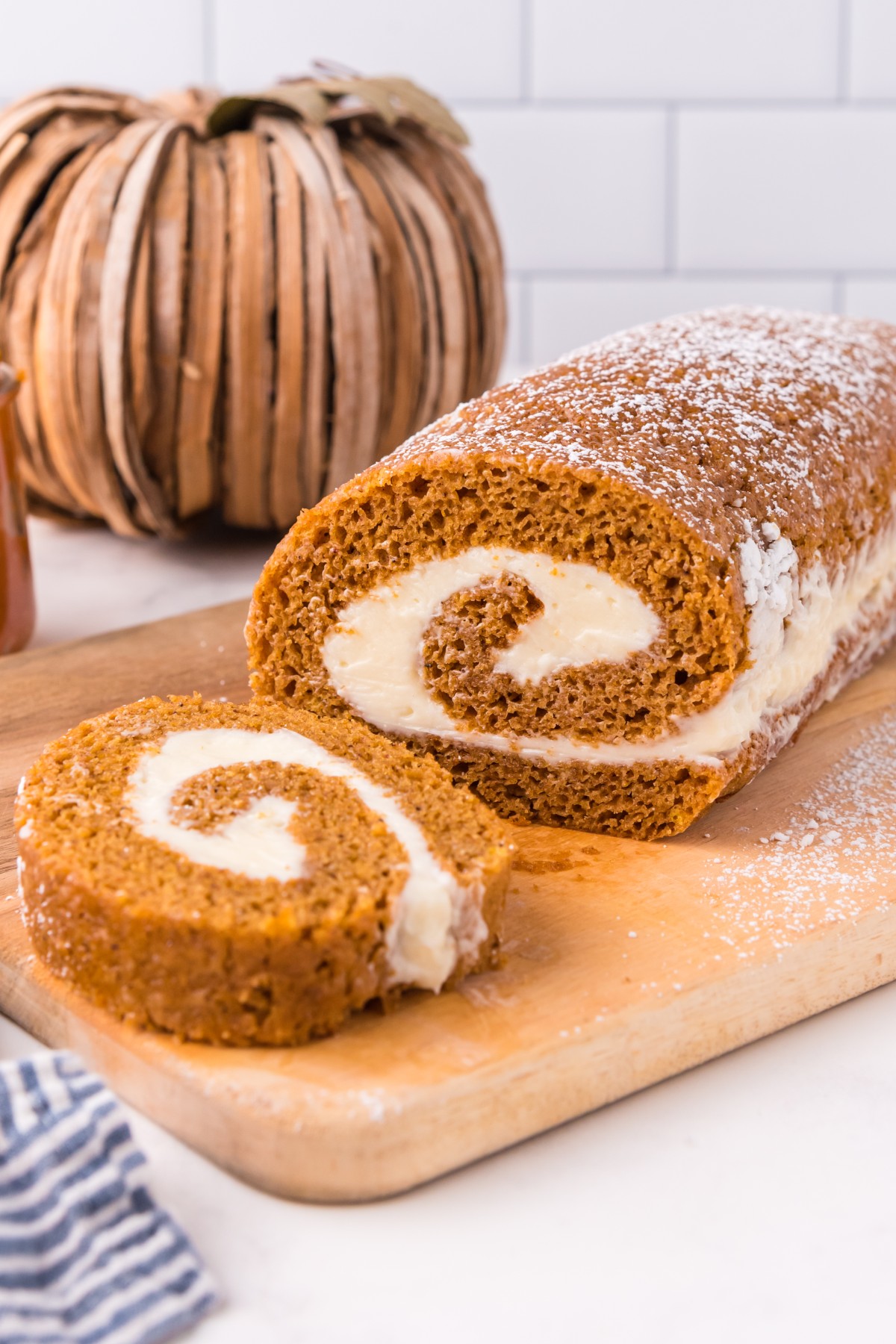 Slices of pumpkin roll on a wooden board.