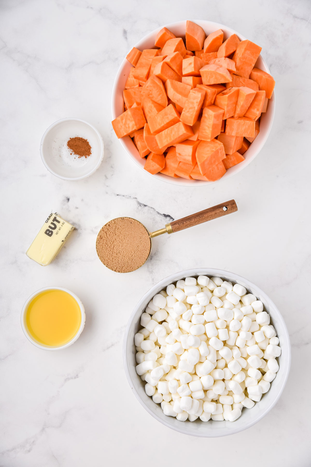 Ingredients for Sweet Potato Casserole with Marshmallows. These are the following: sweet potatoes, brown sugar, melted butter, orange juice, ground cinnamon, mini marshmallows