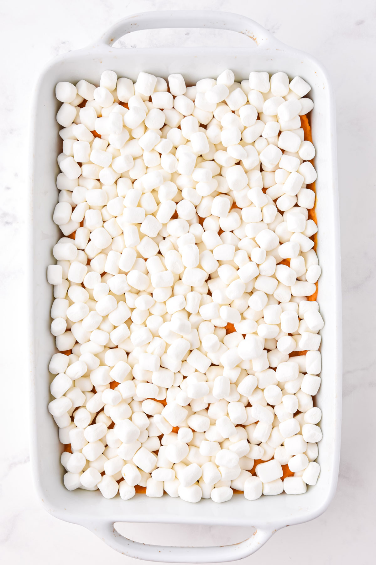 Sweet Potato Casserole with Marshmallows on a tray topped with mini marshmallows. 