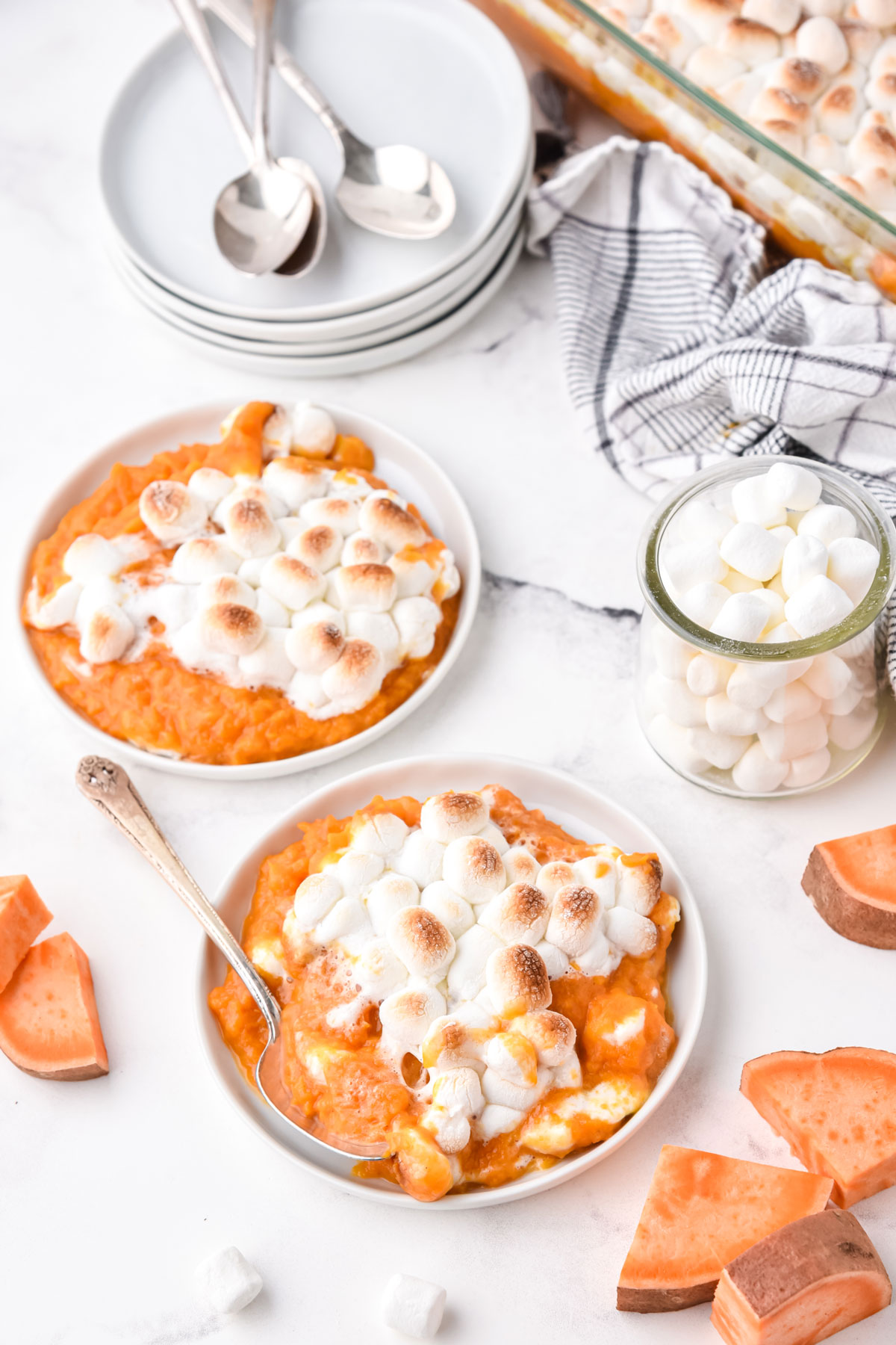 A portion of Sweet Potato Casserole with Marshmallows on a white dessert plate