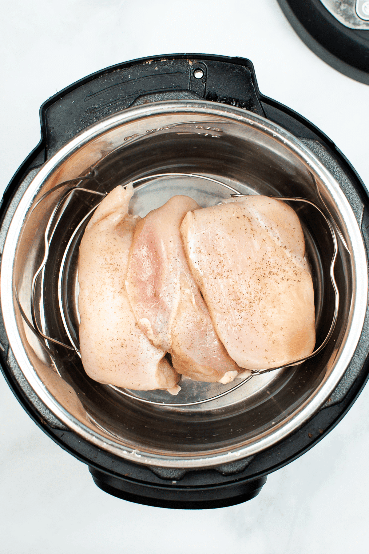 Adding the chicken meat to boil in instant pot