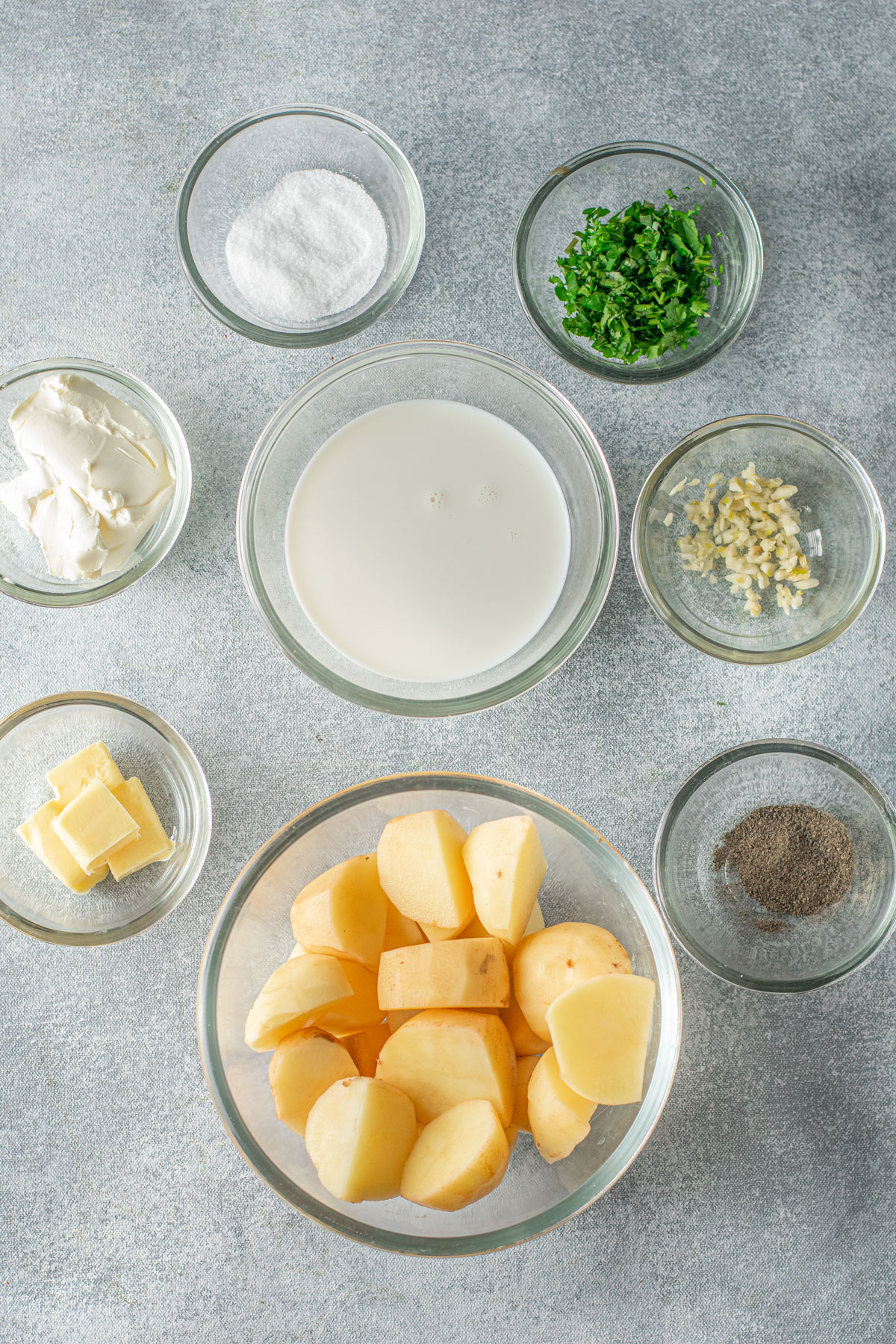 Ingredients of Instant Pot Garlic Mashed Potatoes. These includes potatoes, salt, milk, cream cheese, crushed black pepper, chopped cilantro, water, real butter