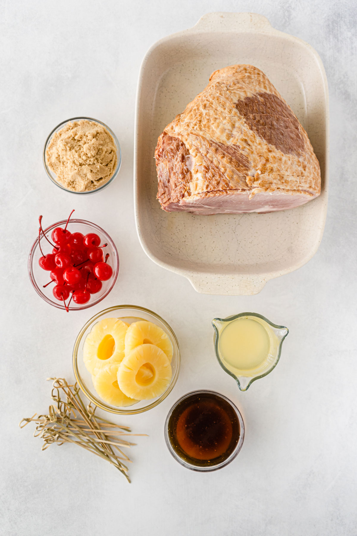 Ingredients for Pineapple Ham with Brown Sugar Marinade. These are the following: ham, pineapple rings, maraschino cherries, 1/2 cup honey, 1/2 cup brown sugar, and 1 cup reserved pineapple juice.

