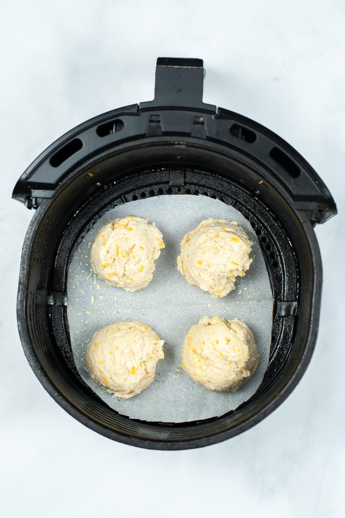 Scoops of Red Lobster Cheddar Biscuits in an air fryer