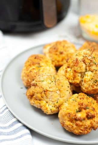 Baked Red Lobster Cheddar Biscuits on a plate with linens