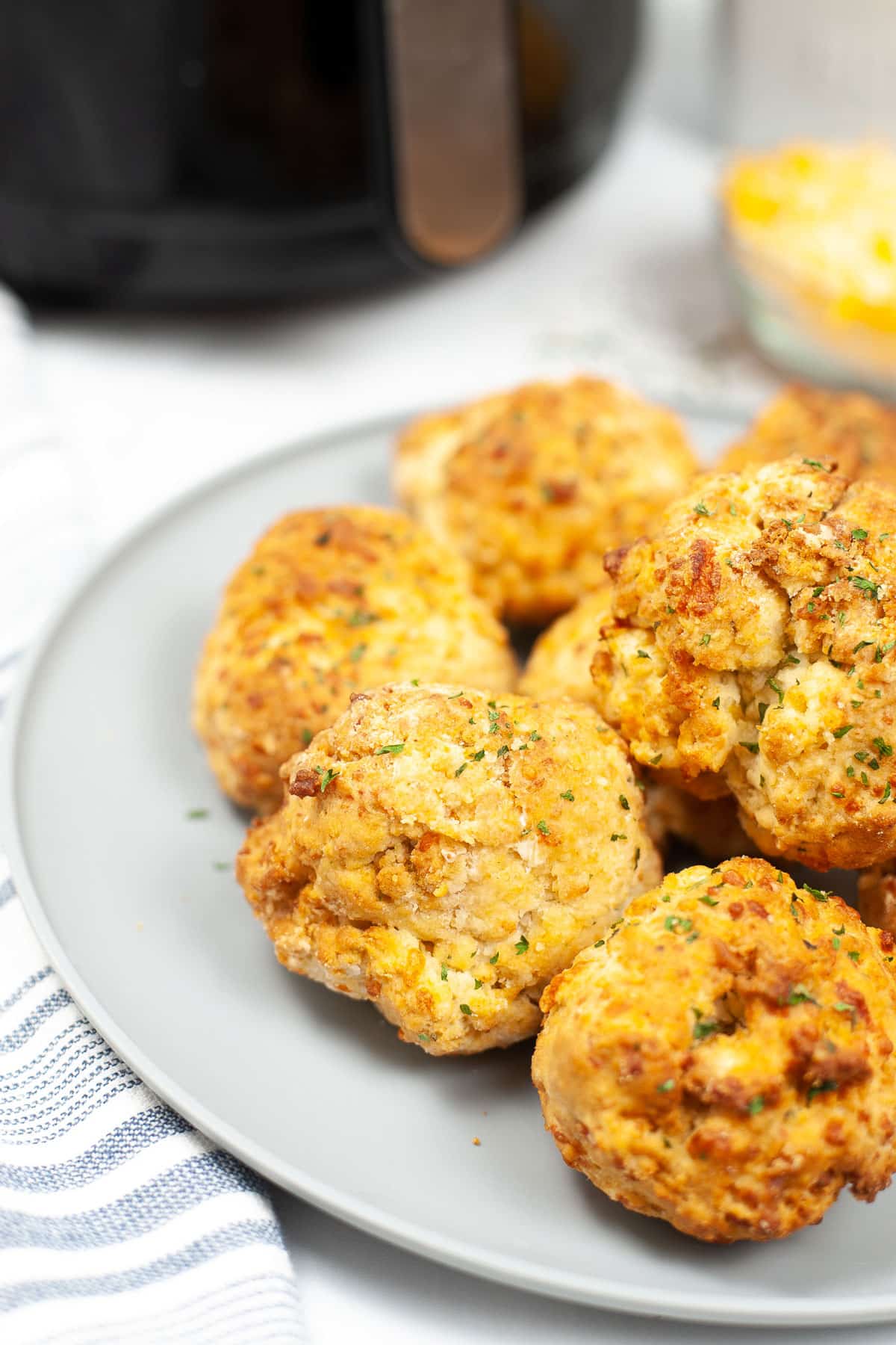 Baked Red Lobster Cheddar Biscuits on a plate with linens