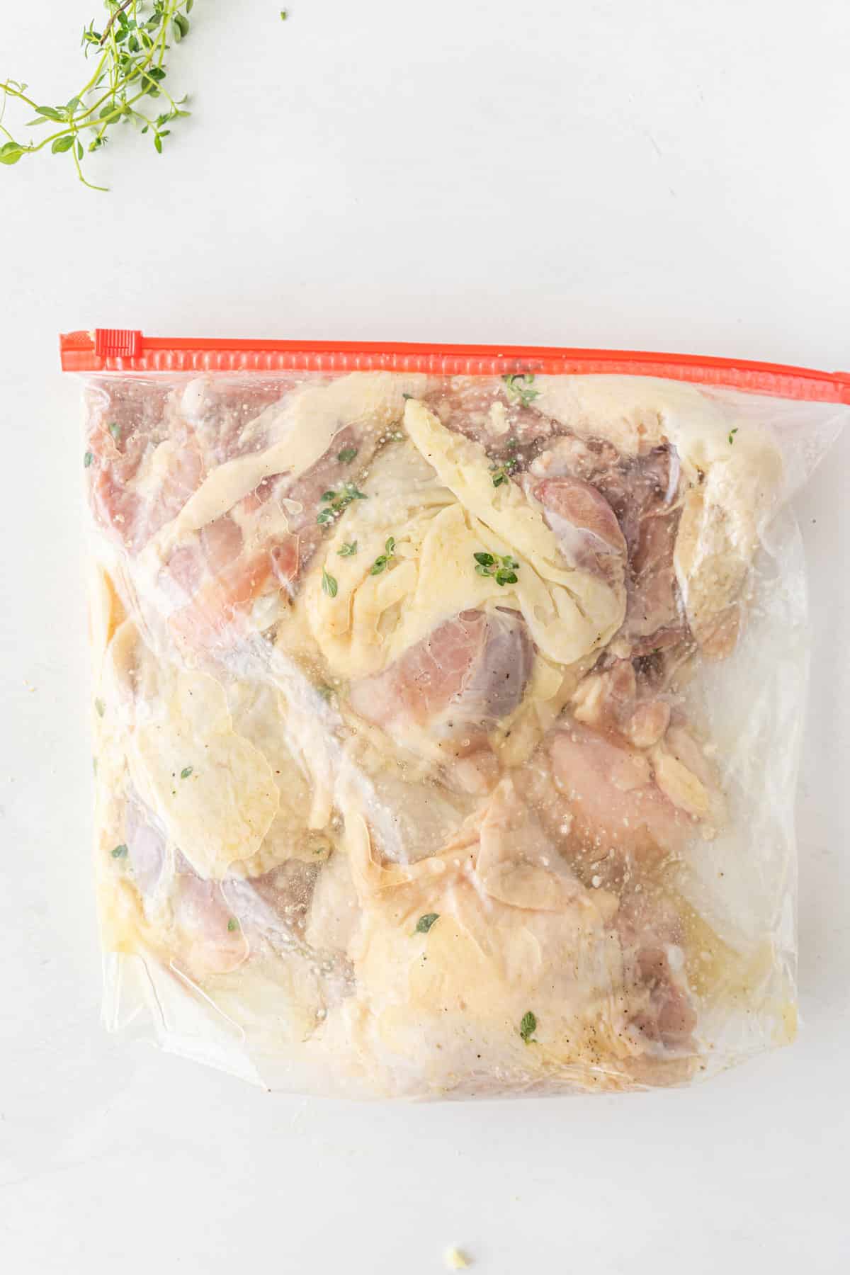 Marinating the meat for Sheet pan Chicken Thighs recipe in a bag