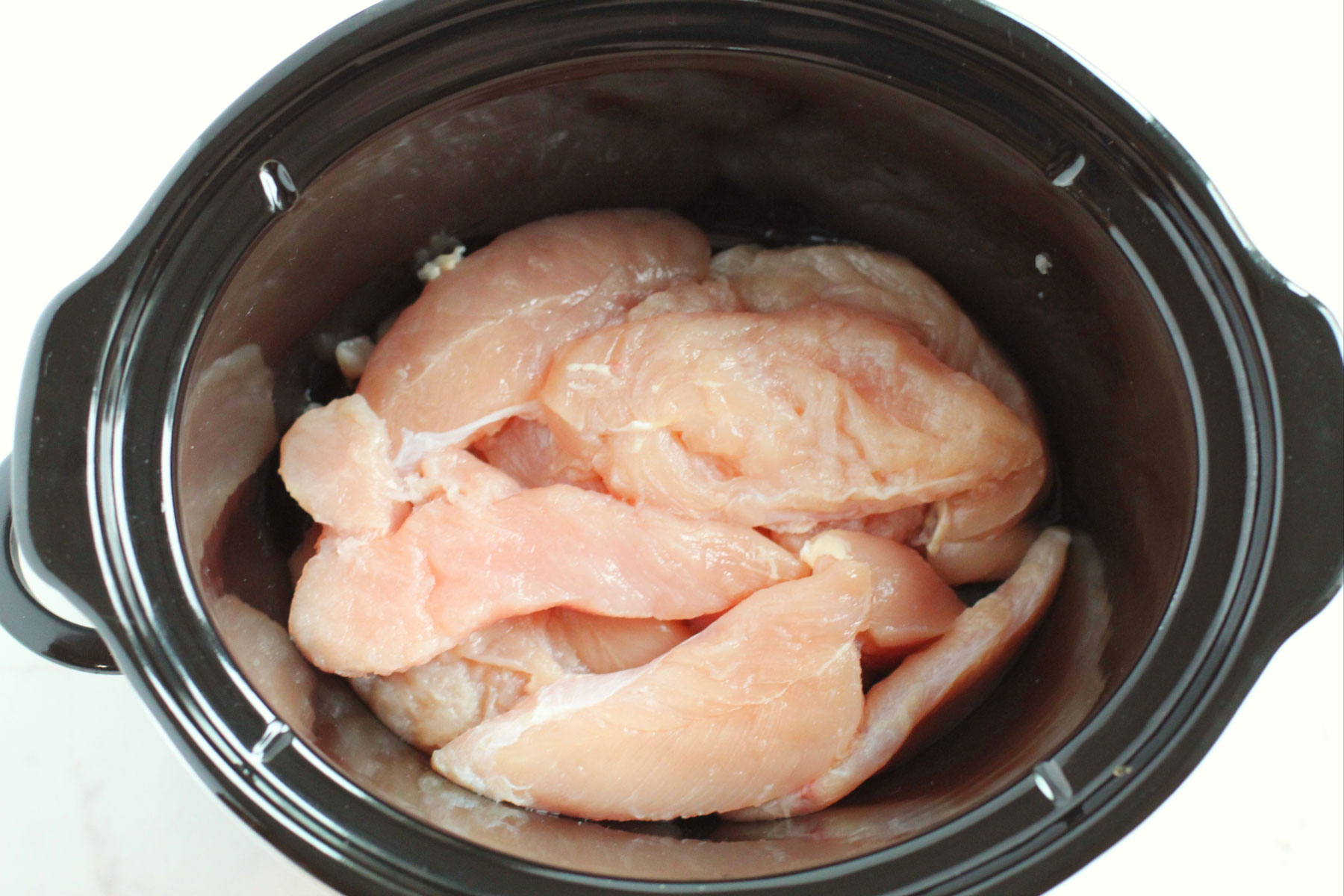 Slow Cooker Chicken Teriyaki process. The chicken was added to a bowl.