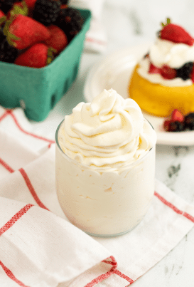 Stabalized Whipped Cream on a transparent glass with linens on the side