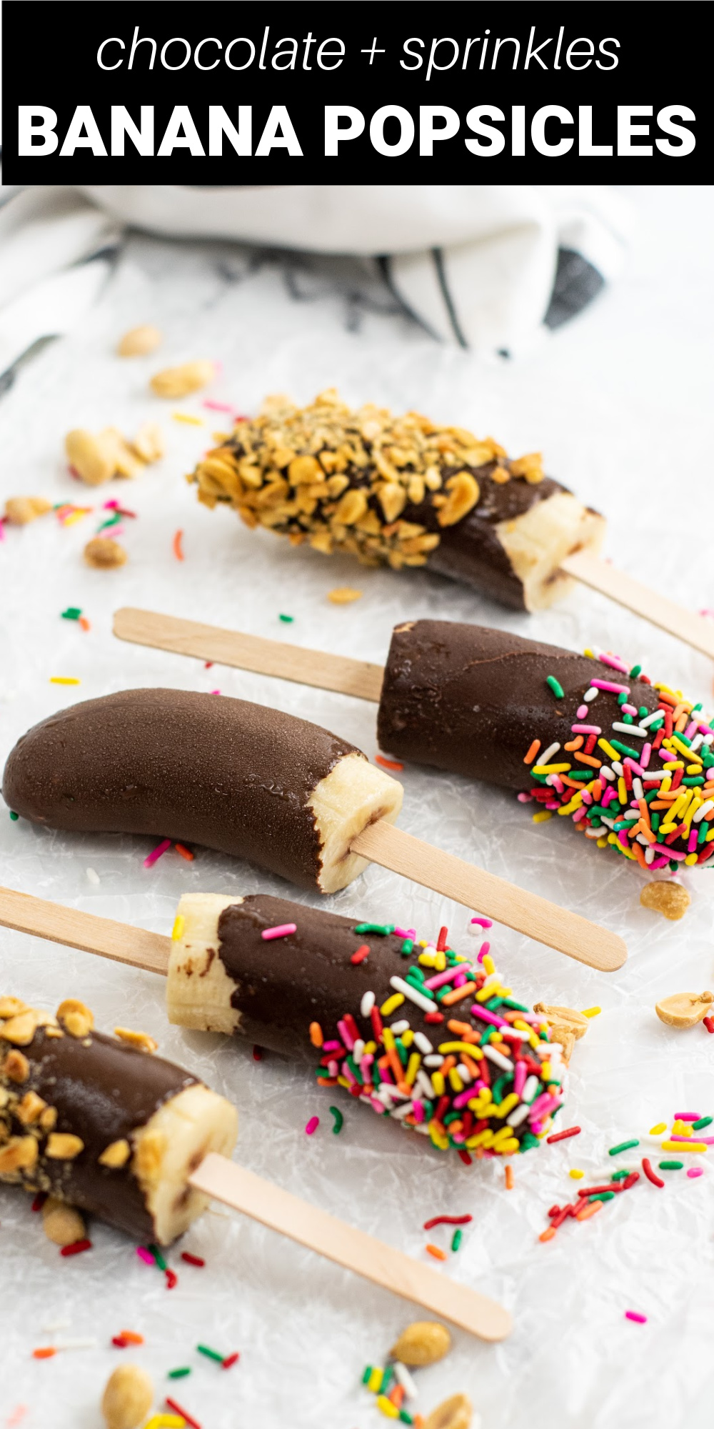 These Chocolate Covered Frozen Banana Pops are made by covering freshly frozen bananas in melted chocolate and adding crushed peanuts and sprinkles on top.