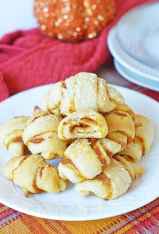 pumpkin crescent rolls stacked on plate