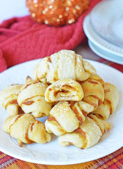 pumpkin crescent rolls stacked on plate