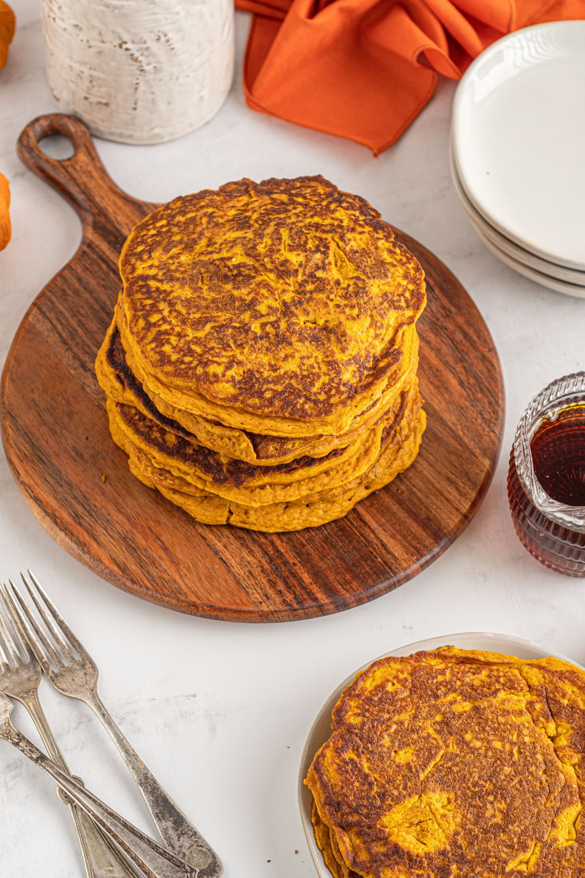 pumpkin pancakes stacked on wooden board