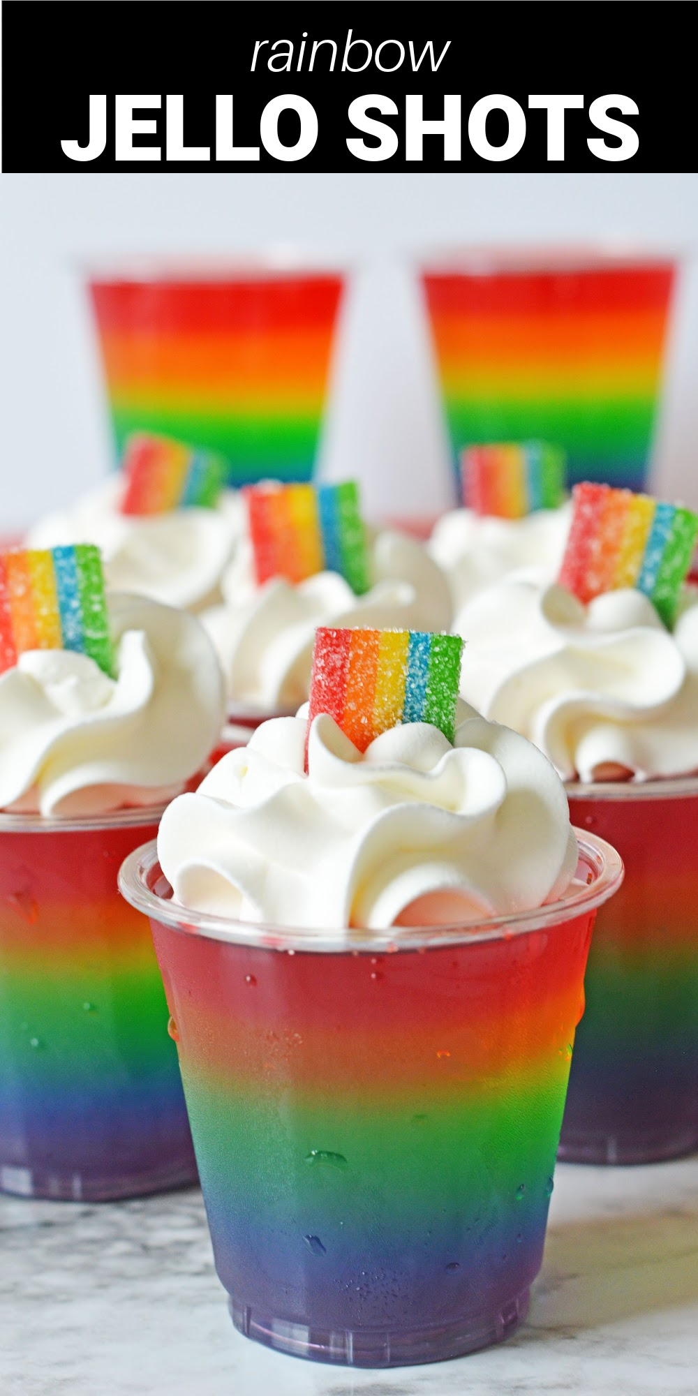 Rainbow Jello Shots are made by layering vibrantly fruity jello mixed with vodka into small cups, and topping it off with Cool Whip and Rainbow Berry Airheads to finish. They are so cute and colorful, they are the perfect adult-only treats for any summer gathering or barbecue.