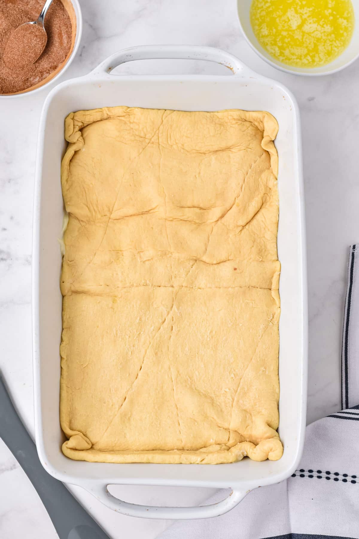 Crescent Roll Cheesecake Bars covered by another layer