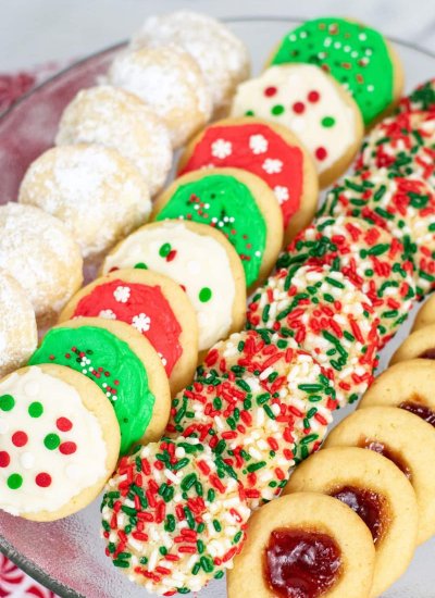 four different Christmas cookies on plate