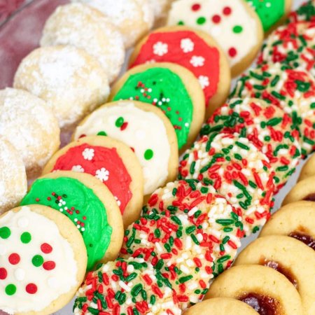 four different Christmas cookies on plate