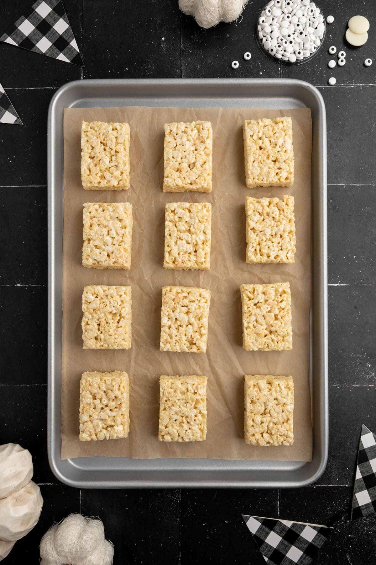 Another process of preparing Mummy Rice Krispies Treats is to arrange the krispies on trays