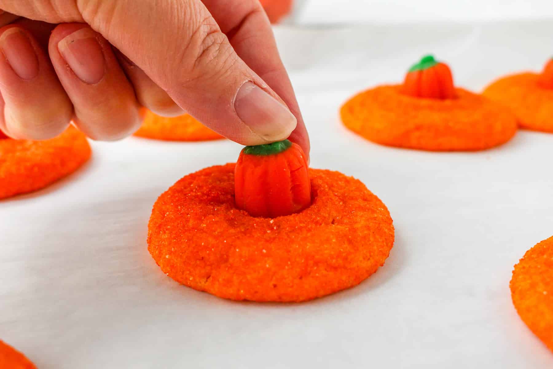 Process of making Pumpkin Blossoms is to add candy pumpkins on top