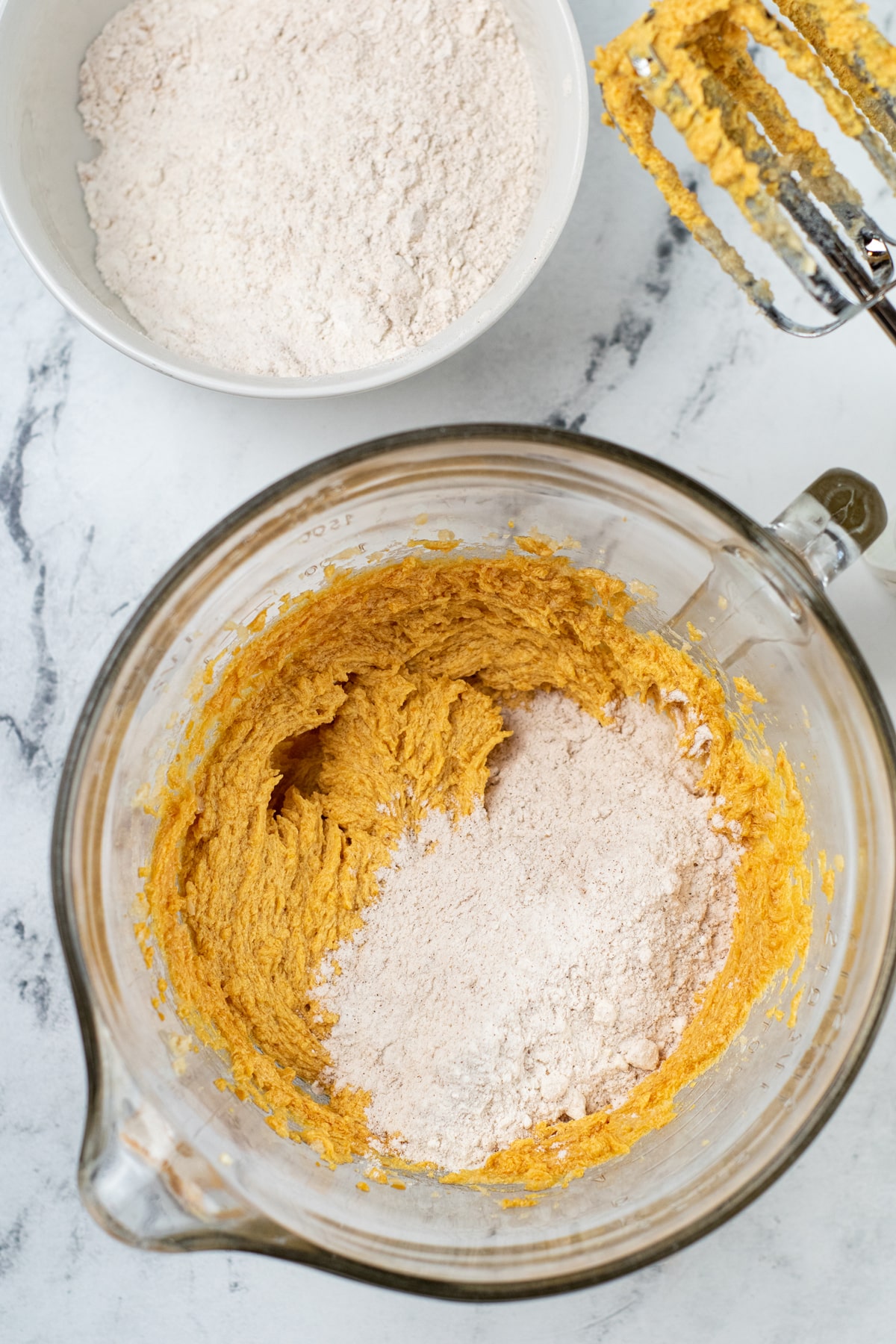 Another step in preparing pumpkin snickerdoodles is to add the flour mixture to the pumpkin mixture gradually
