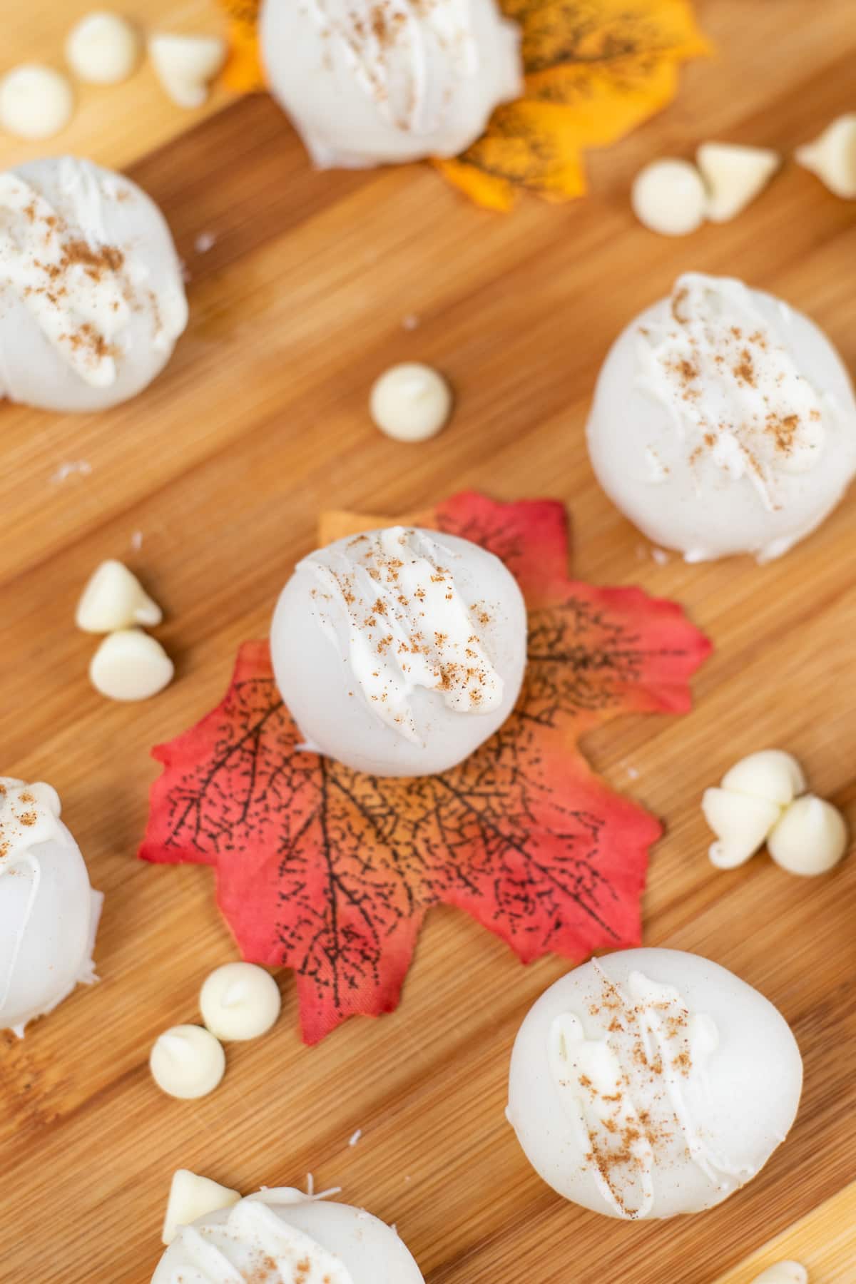 Pumpkin Truffles on a wooden board with decorations on the side