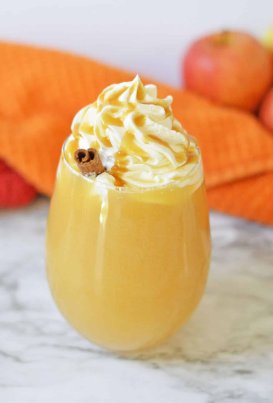 apple cider in glass with whipped cream and caramel