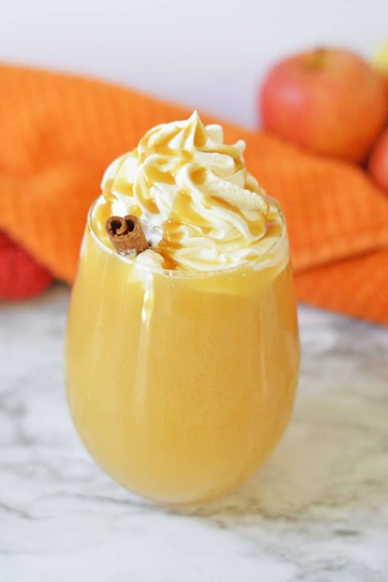 apple cider in glass with whipped cream and caramel