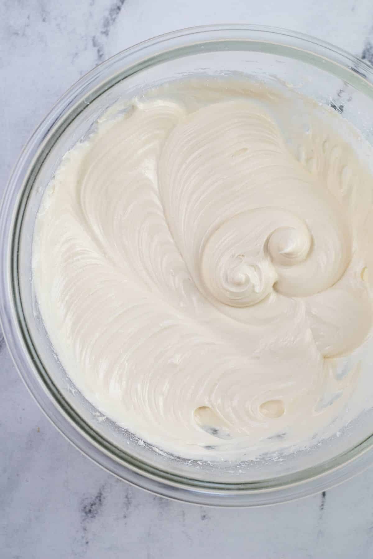 creamy frosting with peaks in bowl
