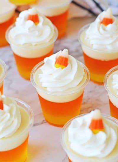 Candy corn jelly cups with whipped cream and candy corn.