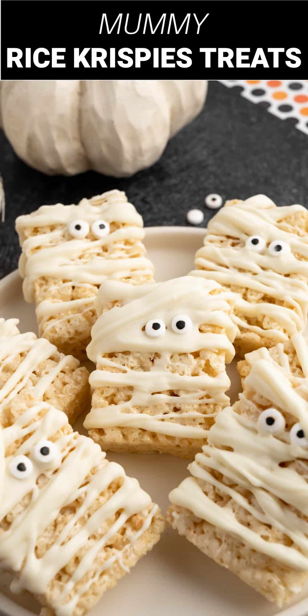 These mummy Krispies treats are an adorable and fun addition to any Halloween party or school event. Chewy and delicious Rice Krispies treats are decorated with creamy white chocolate drizzle and candy eyeballs to turn them into cute and spooky mummy treats that are also super quick and easy.