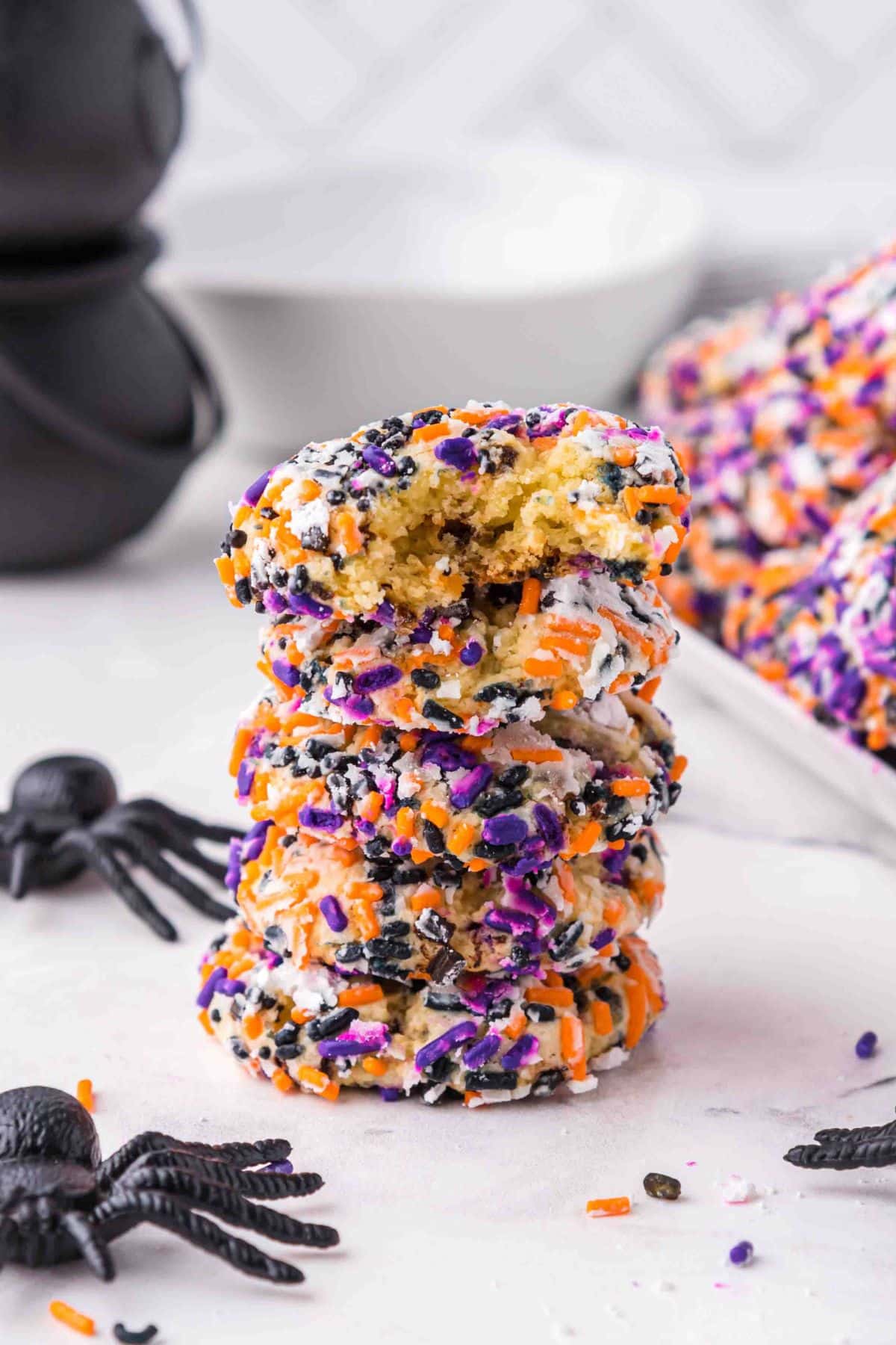 yellow butter cookies with Halloween sprinkles stacked on counter
