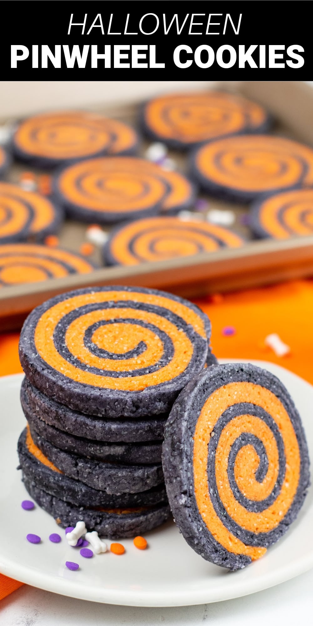 These Halloween pinwheel cookies are a perfect delicious and eye-catching treat for your next Halloween party. Rich and buttery sugar cookie dough is colored black and orange, then rolled together and cut into discs to reveal a pretty Halloween pinwheel design.
