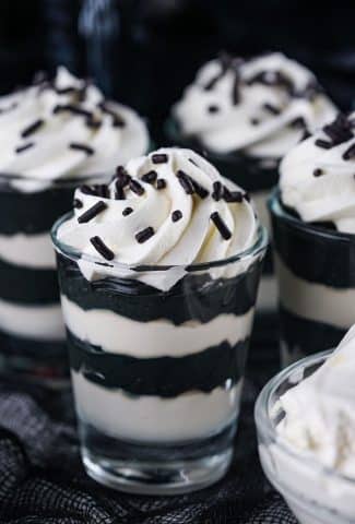 black and white layered pudding shots with whipped cream
